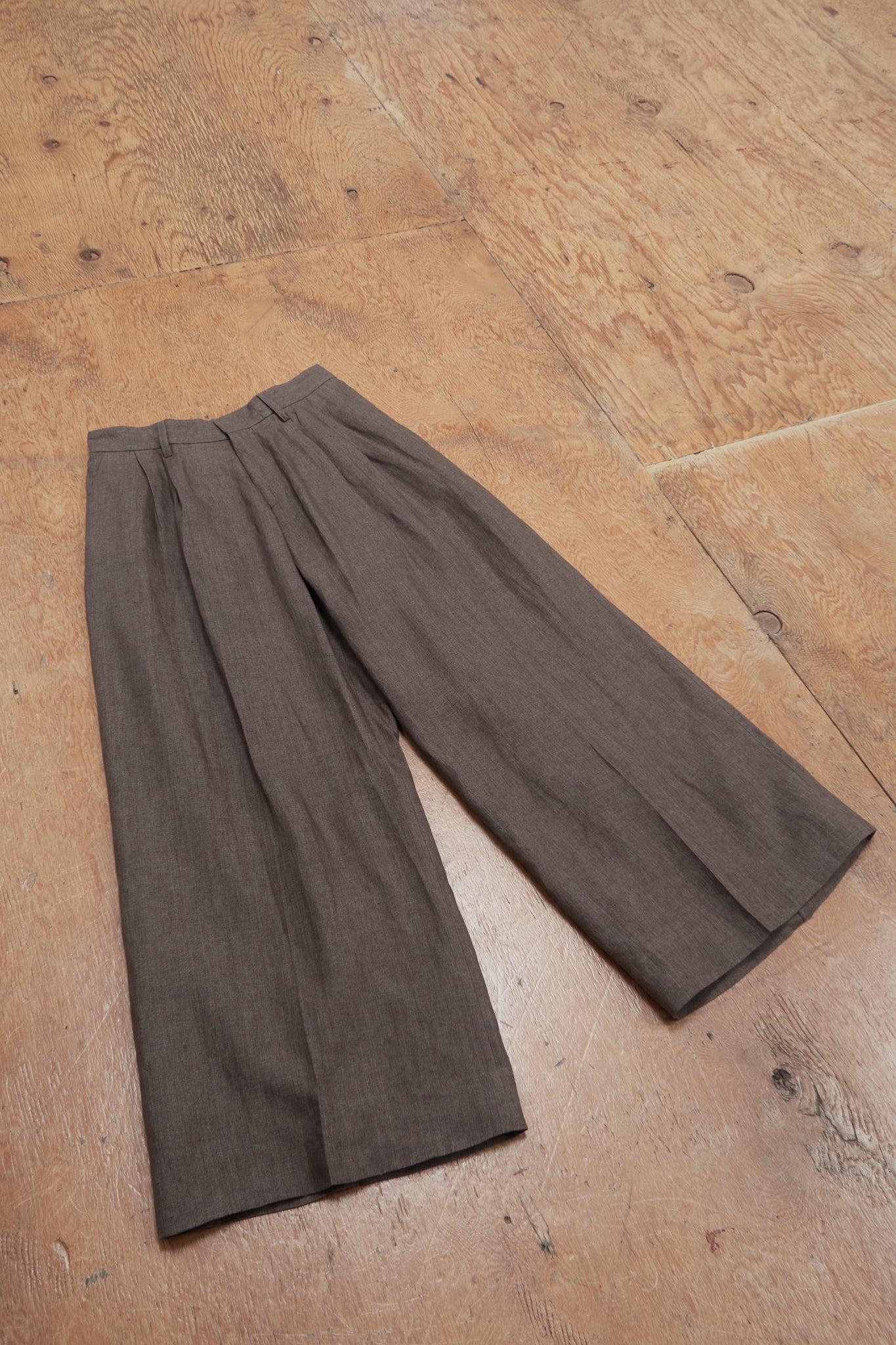 Brown pants on a wooden floor